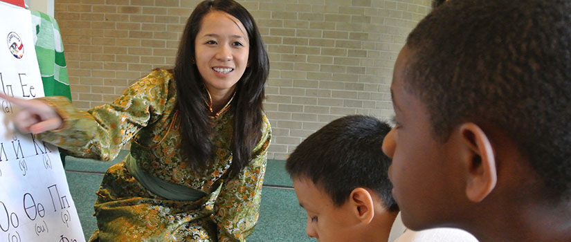 Volunteer teaches foreign alphabet to children at Peace Corp Week. (Courtesy of Peace Corp)