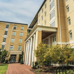 The large green lawn on the left, Honors residence hall front porch is shown to the right.