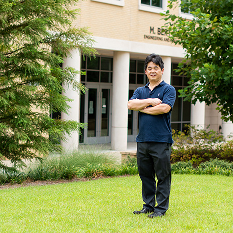 Dr. Hu stands outside the Storey building