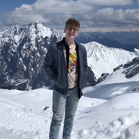 White stands in front of the mountains on his Maymester.
