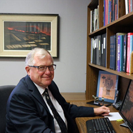 Dr. Dryer sits in his office