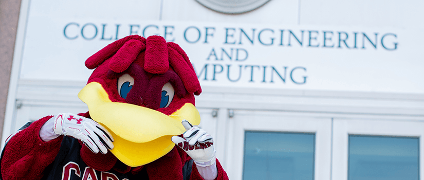 cocky poses in front of the engineering building